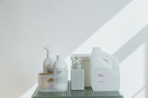 Cleaning Products and Hand Sanitizer Against White Wall
