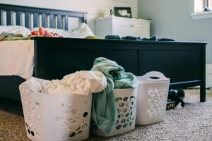 Baskets with Laundry Standing on the Floor by the Bed